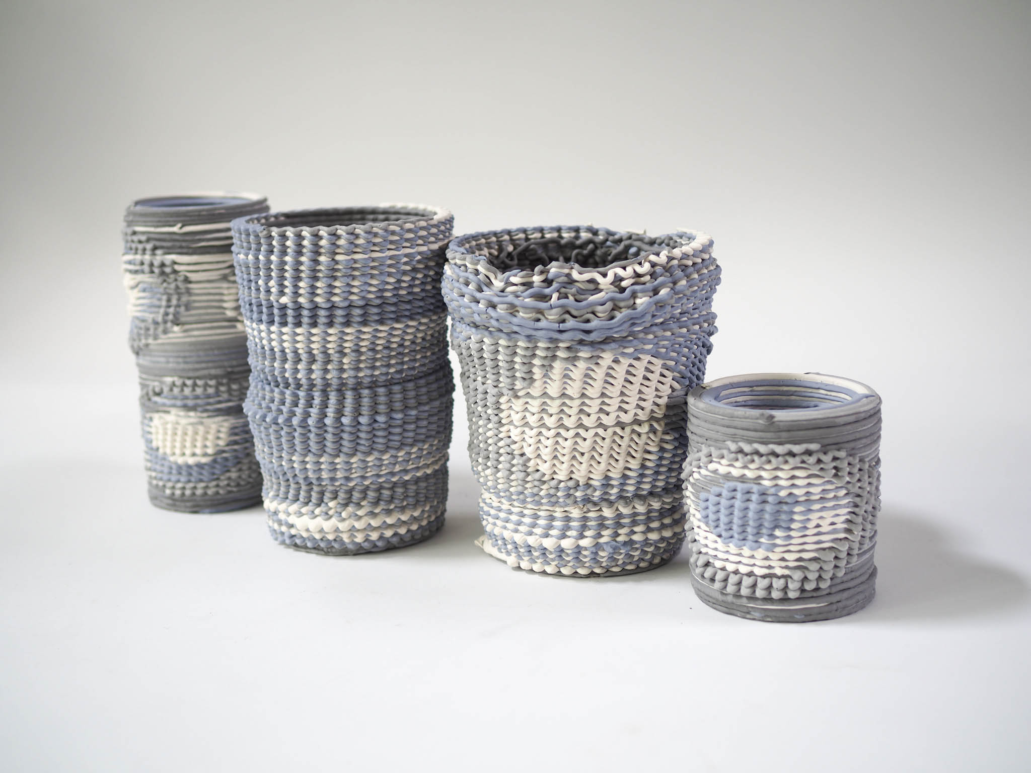 series of four printed ceramic vases