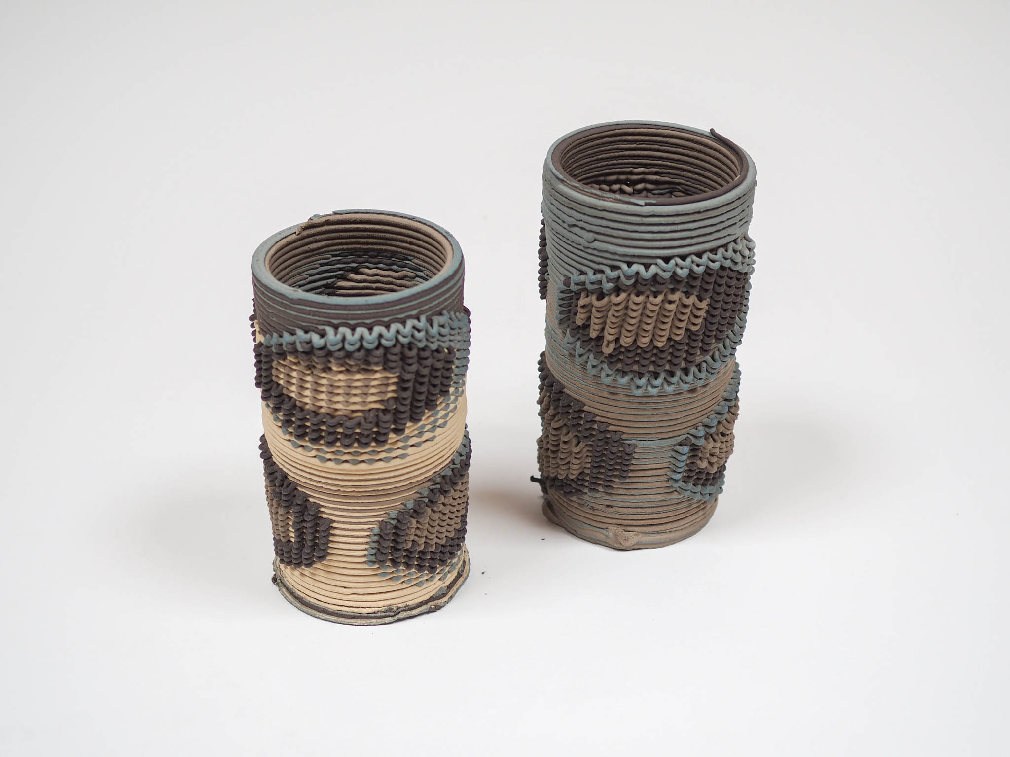 collection of woven ceramic vases